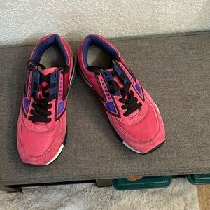 Bright pink Books running shoes.